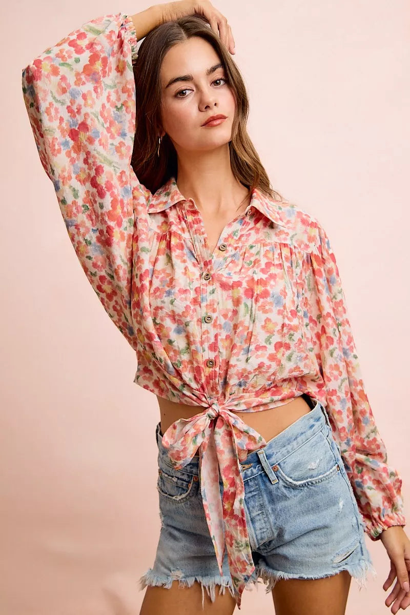 Trendi floral print crop shirt with tie hem detail, featuring long sleeves and a stylish, feminine design.
