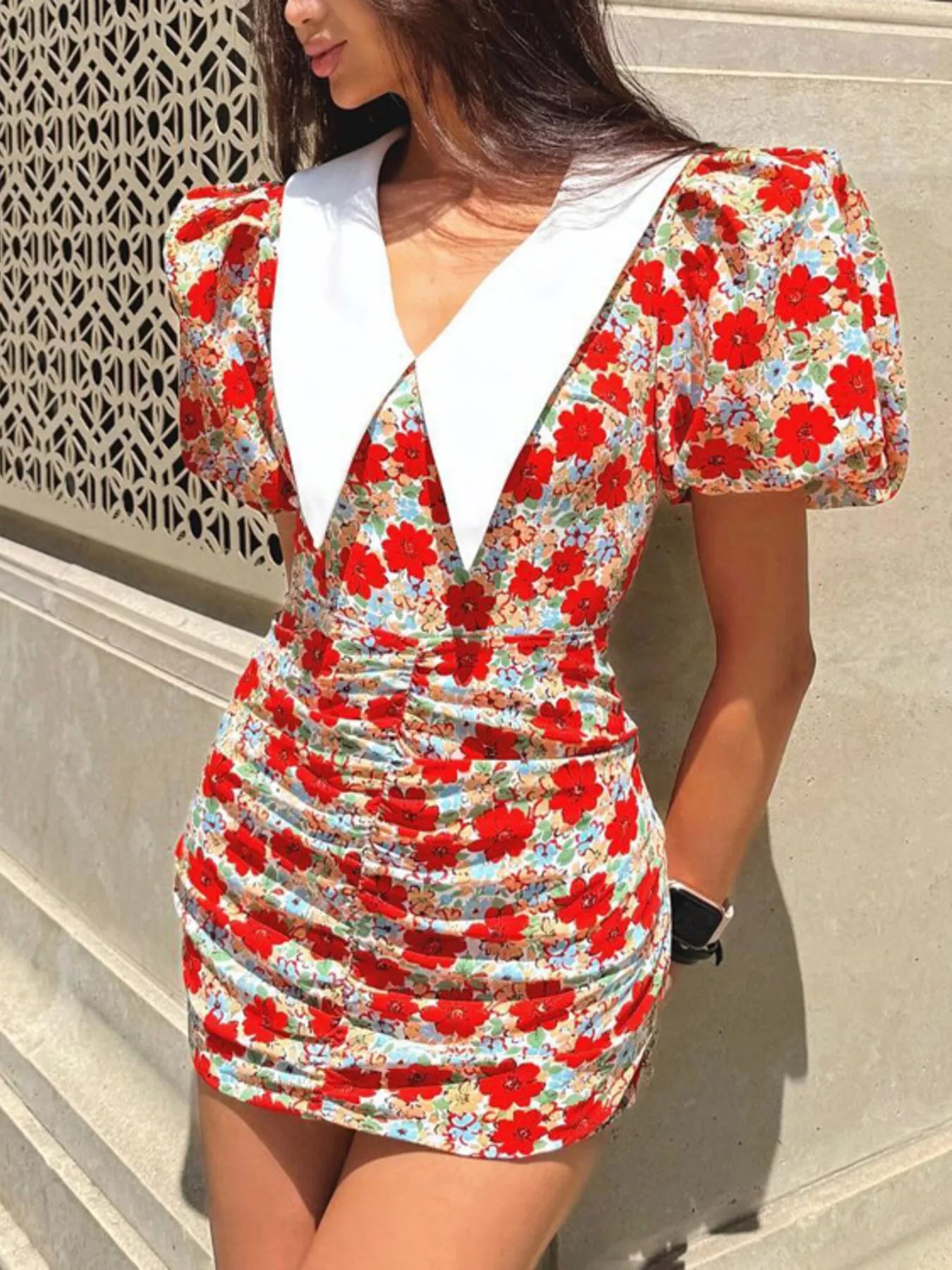 Floral print mini dress with ruched details and puff sleeves, trendy women's fashion by Trendsi in a vibrant floral design.