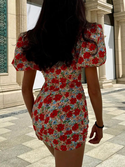 Floral print ruched mini dress with puff sleeves from Trendsi, featuring a fitted bodice and vibrant flower pattern.