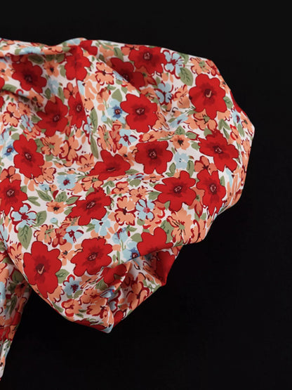 Floral print ruched mini dress with puff sleeves from Trendsi, featuring a fitted bodice and vibrant floral pattern.