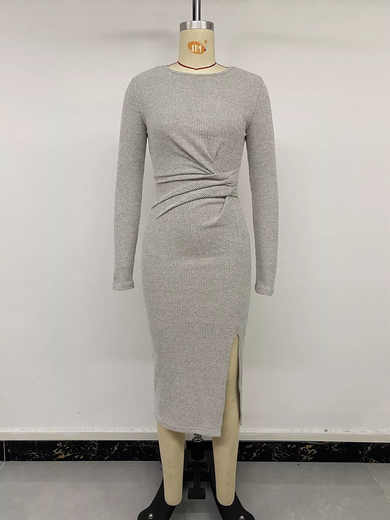 Gray ribbed knit twist front long sleeve midi dress with slit, by Trendsi, featuring a fitted silhouette and stylish design.