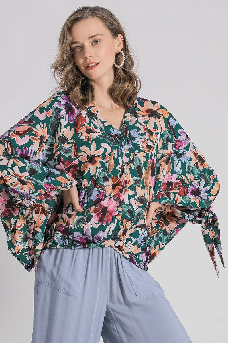 Plus size floral V-neck tie sleeve blouse by Umgee, featuring a relaxed fit and vibrant floral print, perfect for casual wear.