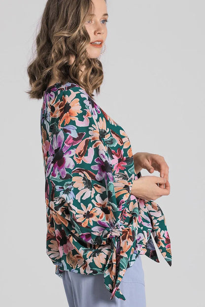 Plus size floral V-neck blouse by Umgee with tie sleeves and full-length floral pattern, perfect for casual or dressy occasions.
