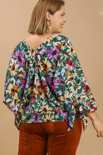 Plus size floral V-neck tie sleeve blouse by Umgee, featuring a full size fit and stylish design, shown on a model.