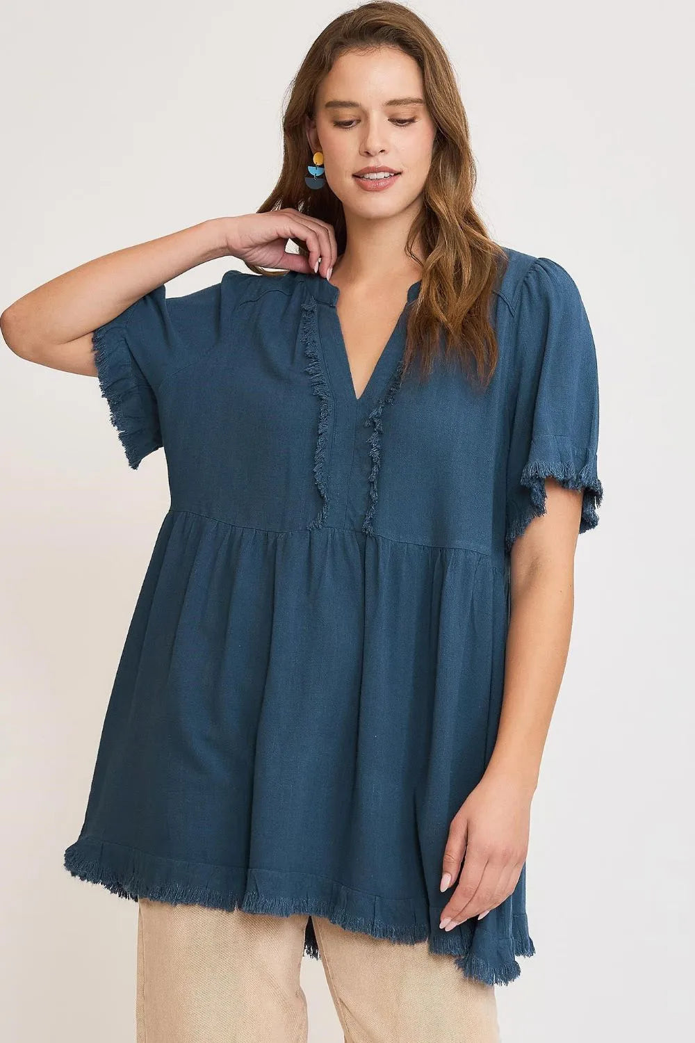 French blue Umgee plus size linen babydoll blouse with raw hem and notched details, featuring a relaxed fit and casual style.