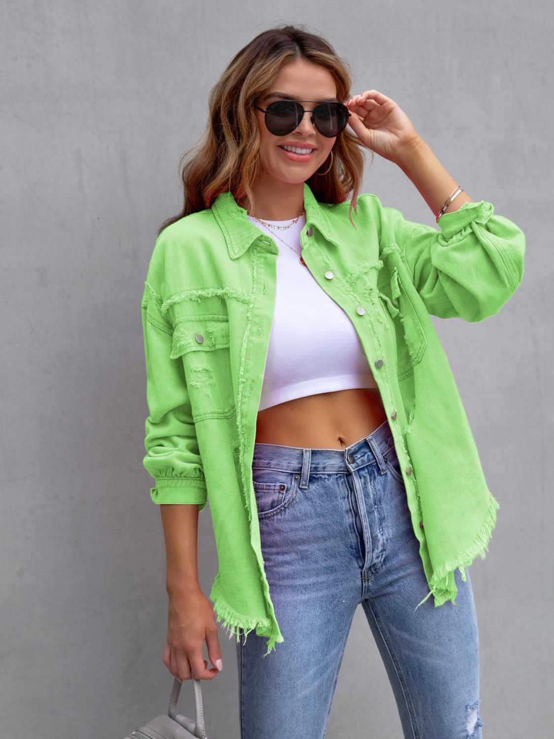 Fuchsia pink distressed drop shoulder denim jacket by Trendsi, featuring a casual, oversized fit with distressed details and long sleeves.