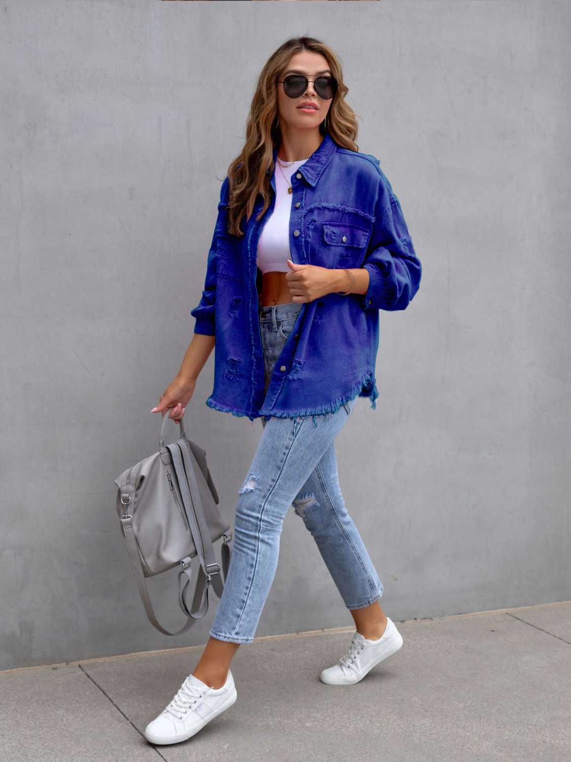 Fuchsia pink distressed drop shoulder denim jacket from Trendsi, with a casual fit and frayed edges, styled on a model.