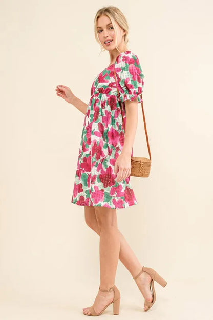 Fuchsia floral smocked ruffle short sleeve mini dress by Trendsi, featuring a feminine design and lightweight fabric.
