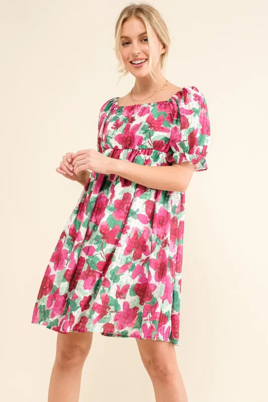 Fuchsia floral smocked ruffle short sleeve mini dress by Trendsi, featuring a feminine design and lightweight fabric.