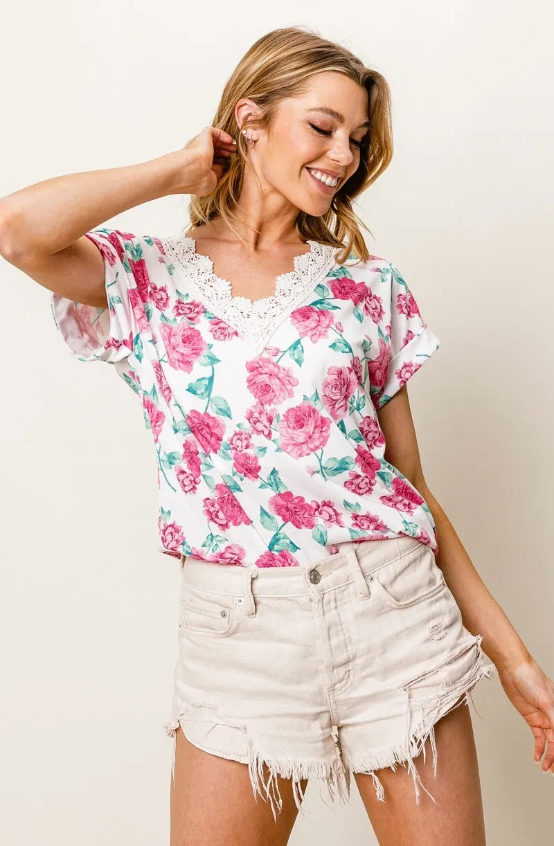 Fuchsia BiBi Rose printed poly span top with crochet lace details, featuring a stylish and feminine design.