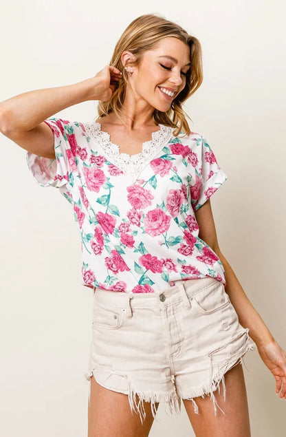 Fuchsia BiBi Rose printed poly span top with crochet lace details, featuring a stylish and feminine design.