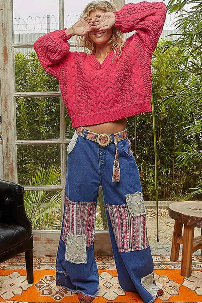 Fuchsia POL Cable-Knit Solid V-Neck Cropped Sweater by Trendsi, showing the textured knit fabric and V-neck design.