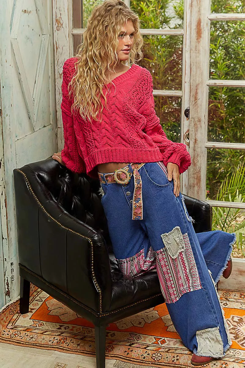 Fuchsia POL Cable-Knit Solid V-Neck Cropped Sweater from Trendsi, showcasing a textured knit fabric and a V-neck design.