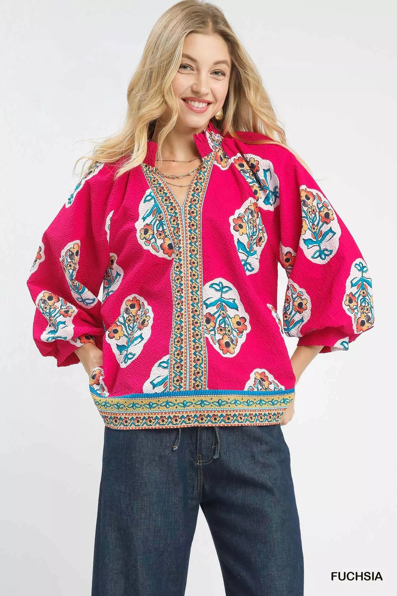 Fuchsia Umgee boho floral print tunic blouse with long sleeves and relaxed fit, featuring vibrant floral patterns.
