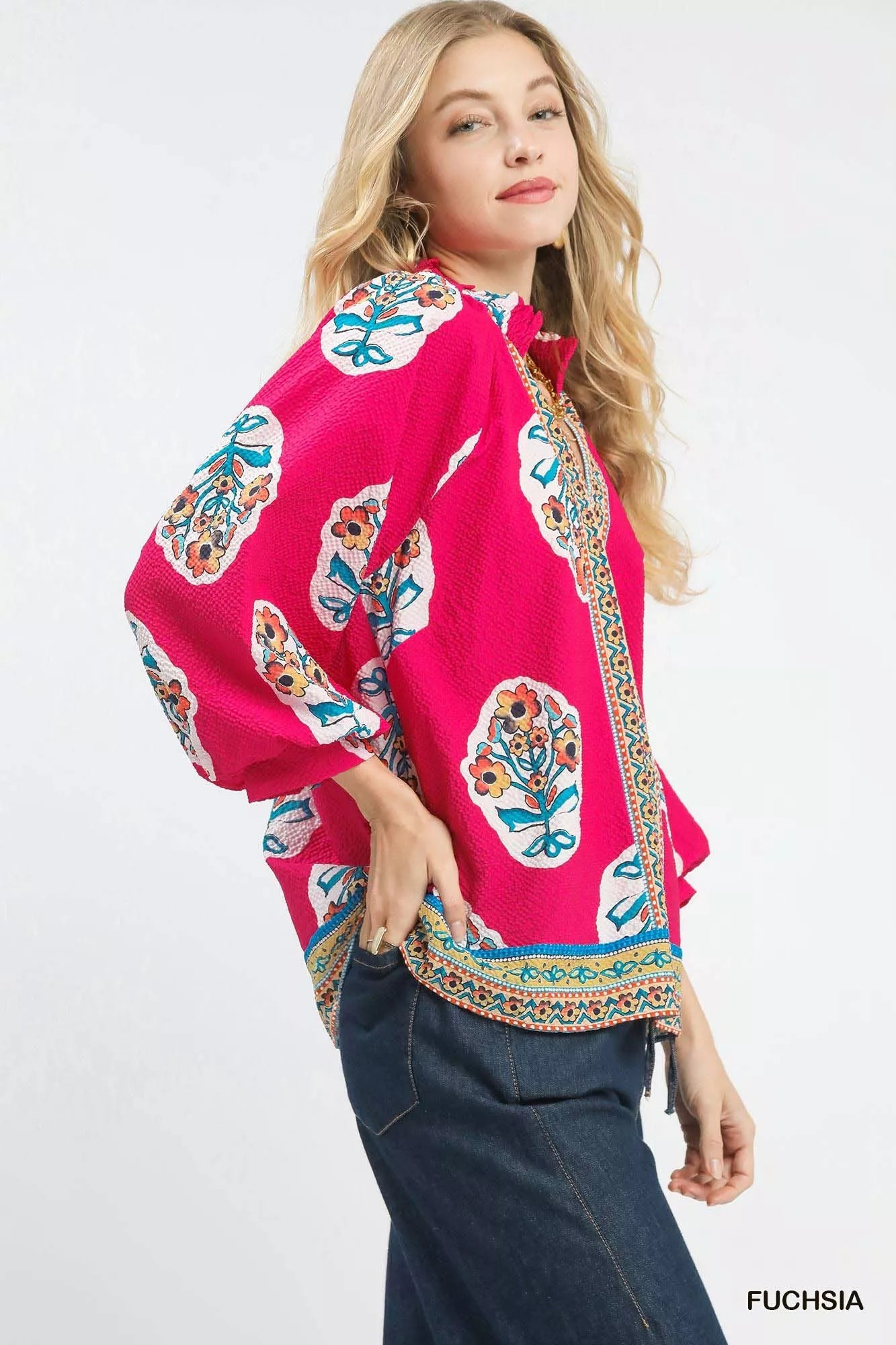 Fuchsia Umgee boho floral print tunic blouse with long sleeves and relaxed fit, styled on a model.