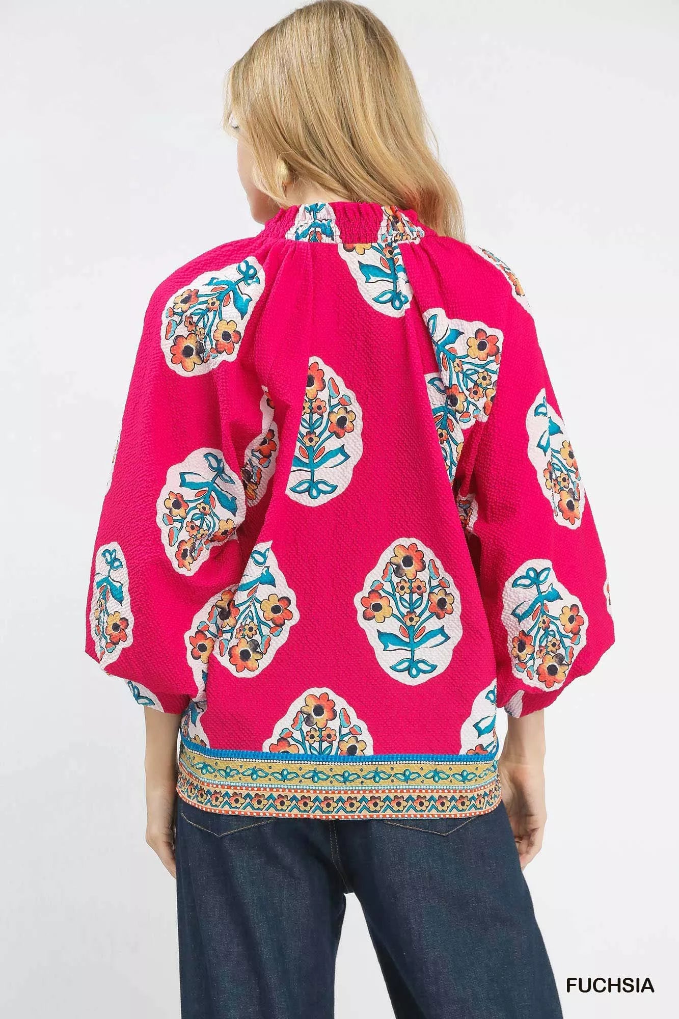 Fuchsia Umgee boho floral print tunic blouse with long sleeves and relaxed fit, styled for casual wear.