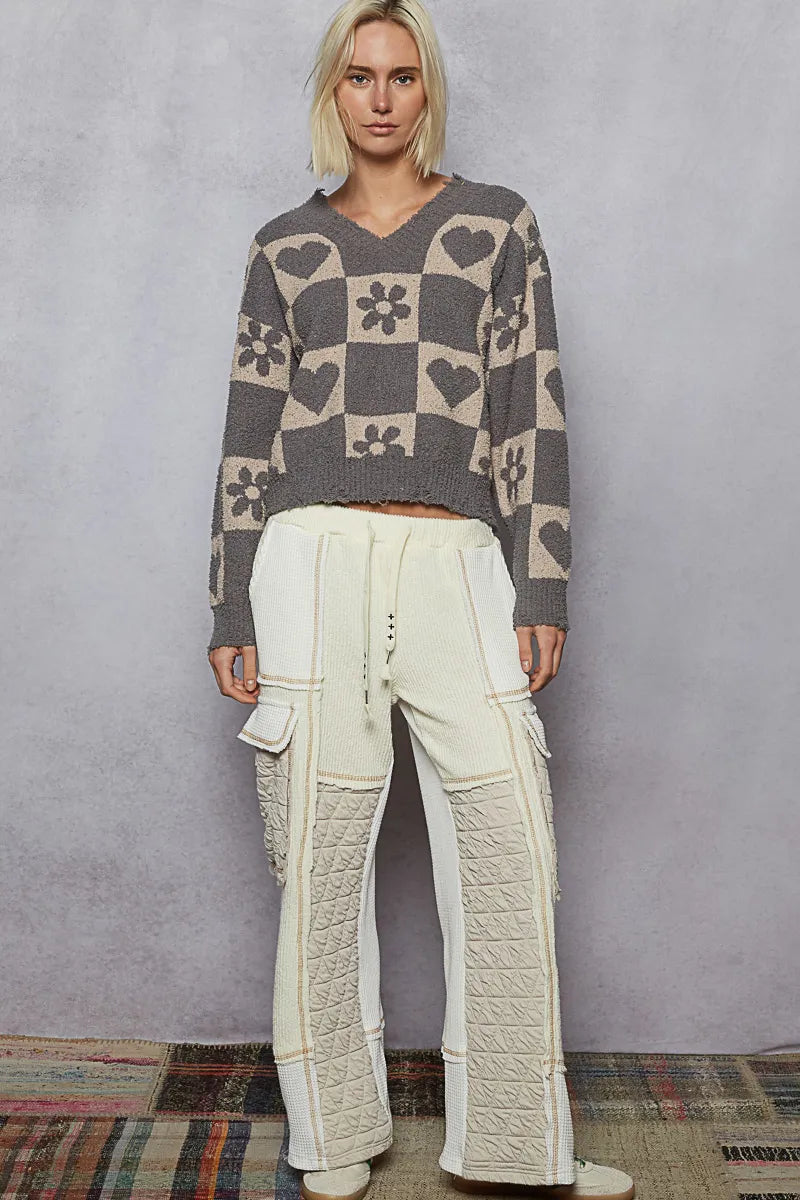 Grey and beige V-neck checkered sweater with heart pattern from Trendsi, featuring a cozy knit design and stylish casual fit.