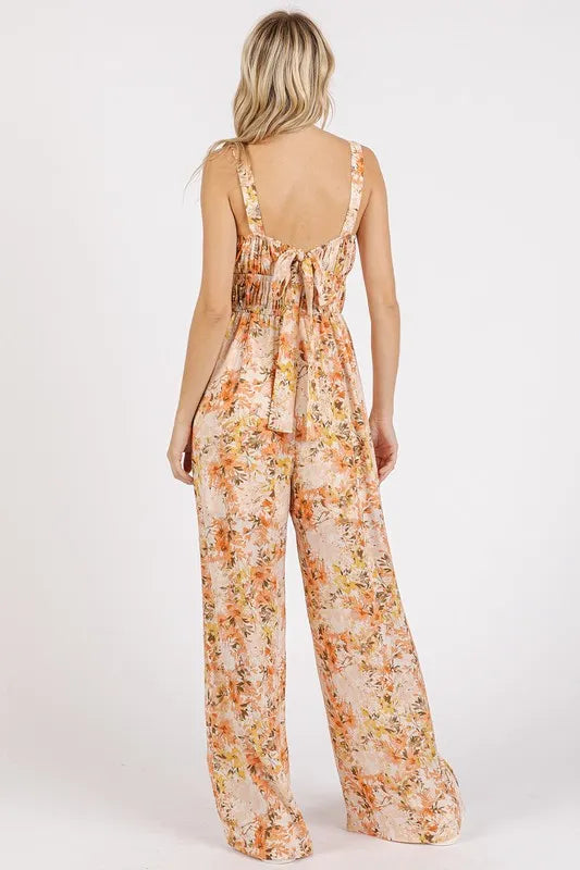 Flower print sleeveless jumpsuit with gathered bust and adjustable straps by Mittoshop, styled in a vibrant floral pattern.