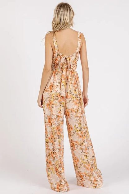 Flower print sleeveless jumpsuit with gathered bust and adjustable straps by Mittoshop, styled in a vibrant floral pattern.