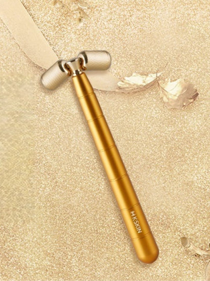 Gold facial massager beauty device by Trendsi, handheld skincare tool for facial massage and skin rejuvenation.