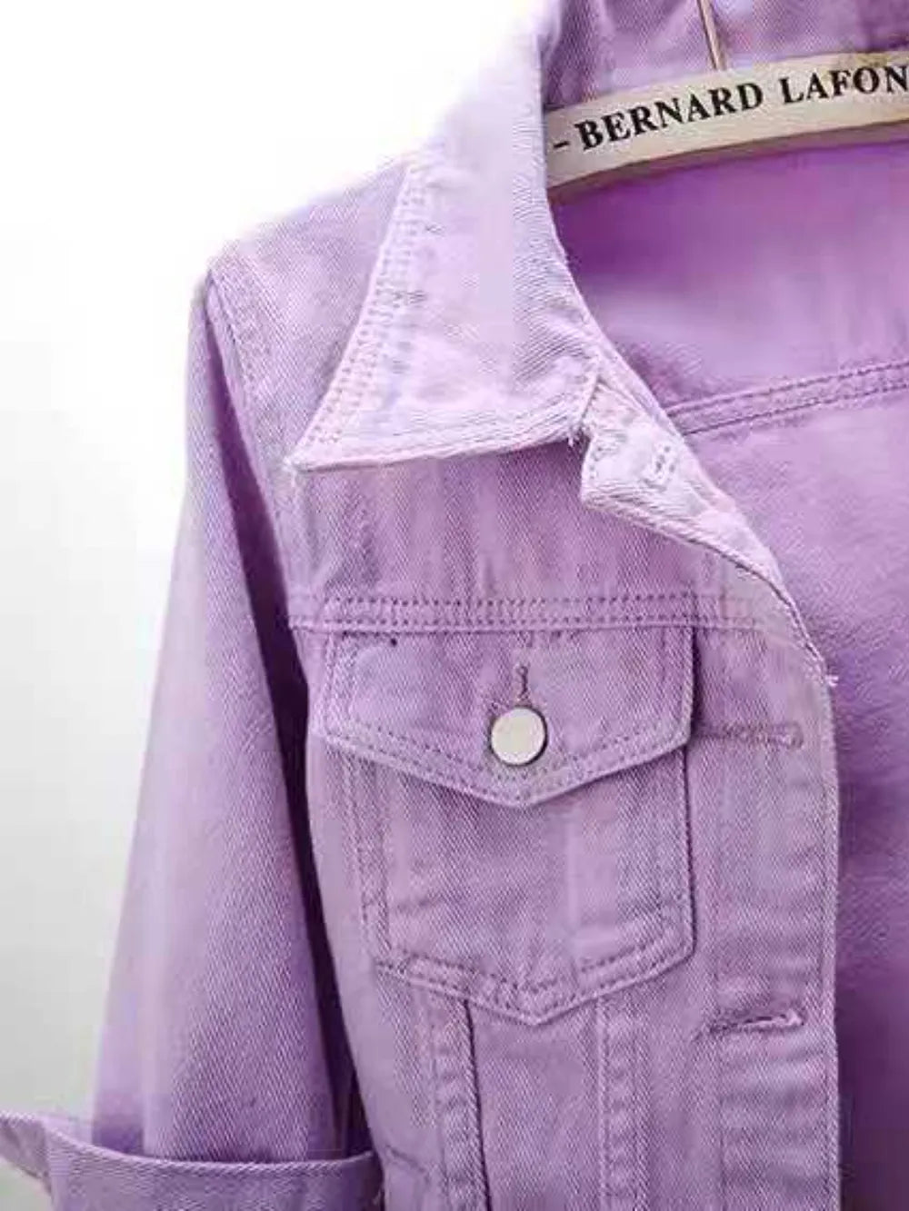 Plus size cropped denim jacket by Trendsi, featuring classic blue denim with gold accents and a stylish, fitted design.
