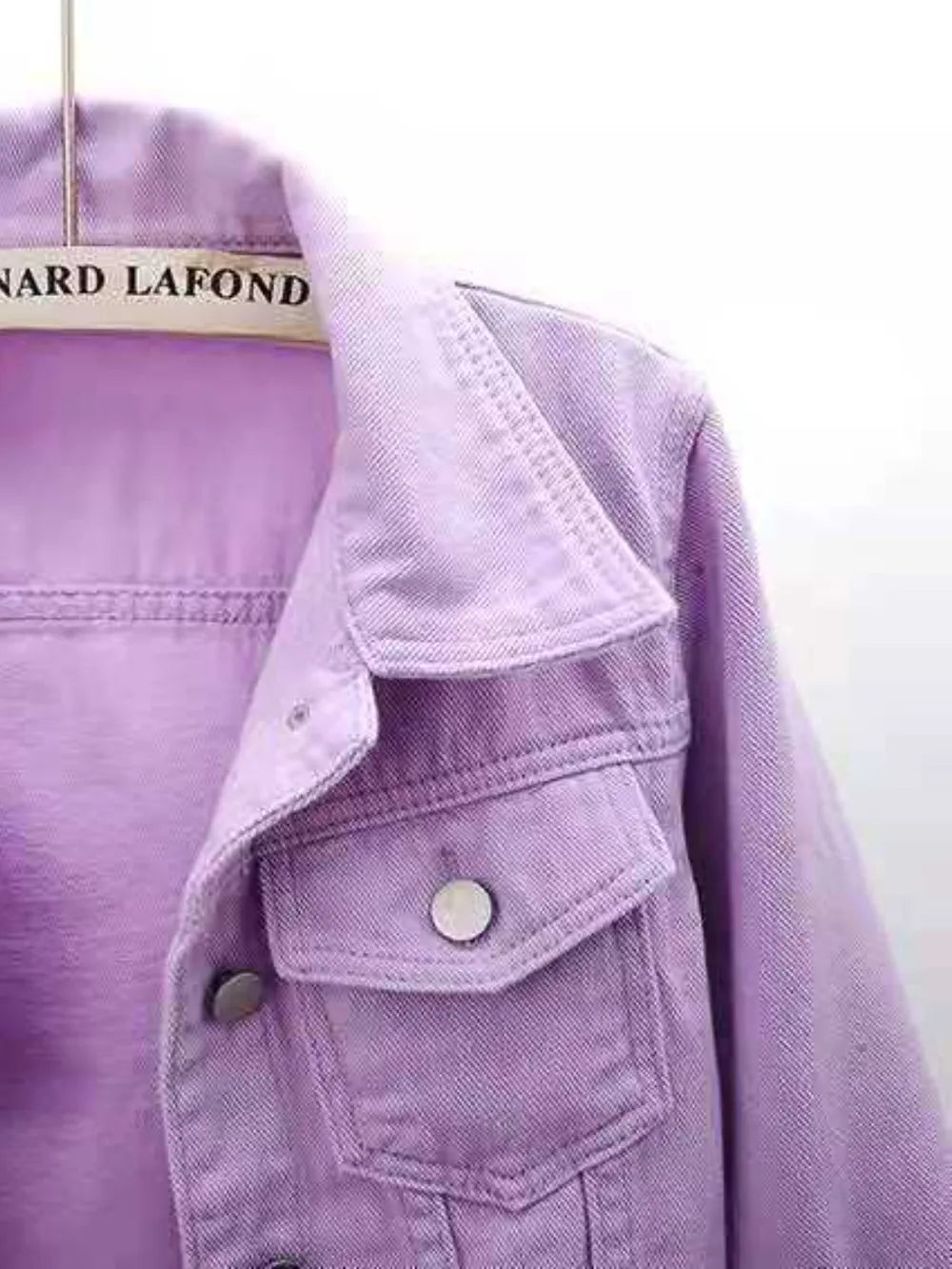 Plus size cropped denim jacket by Trendsi, featuring classic blue denim with stylish collar and button details.