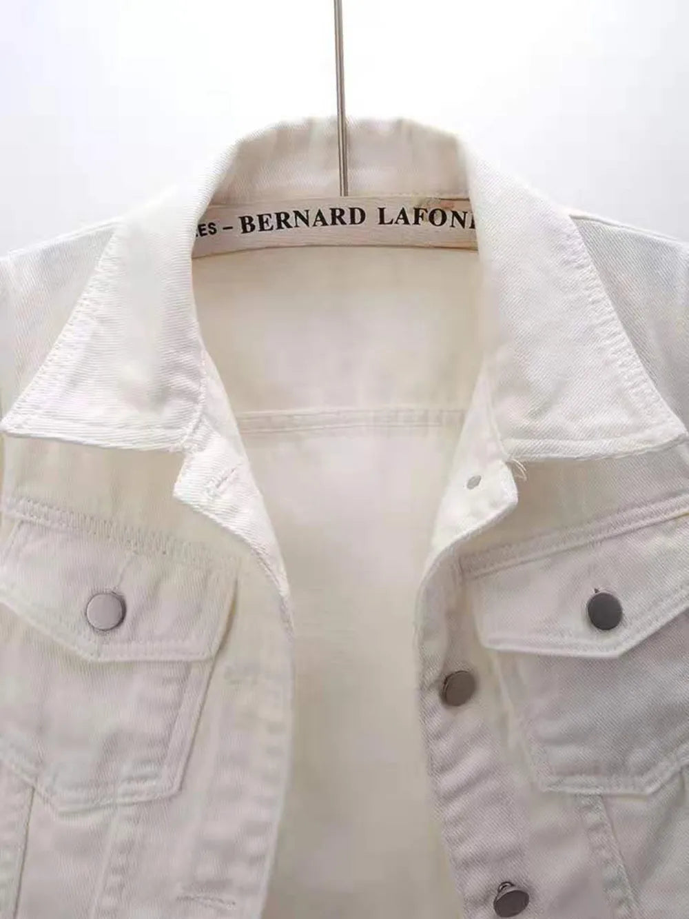 Plus size cropped denim jacket from Trendsi featuring classic blue denim, button closure, and a trendy, casual style.