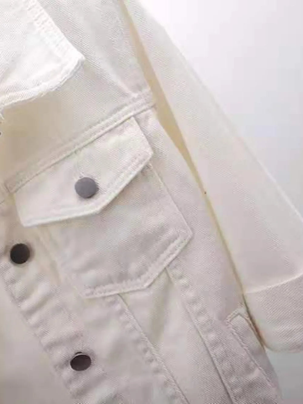 Plus size cropped denim jacket by Trendsi, featuring classic blue denim fabric and a stylish, tailored fit.