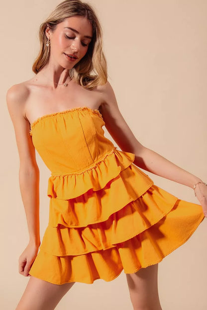Gold strapless ruffle layered cheer-up dress by Trendsi, featuring a flattering fit and festive game day style.