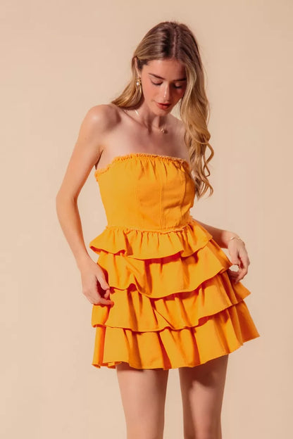Gold strapless ruffle layered cheer-up dress by Trendsi, featuring a playful, tiered design perfect for game day cheerleading.
