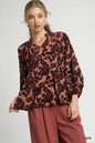 Trendsi Umgee floral velvet blouse with balloon sleeves, showcasing a vibrant floral pattern and elegant, flowy fabric.