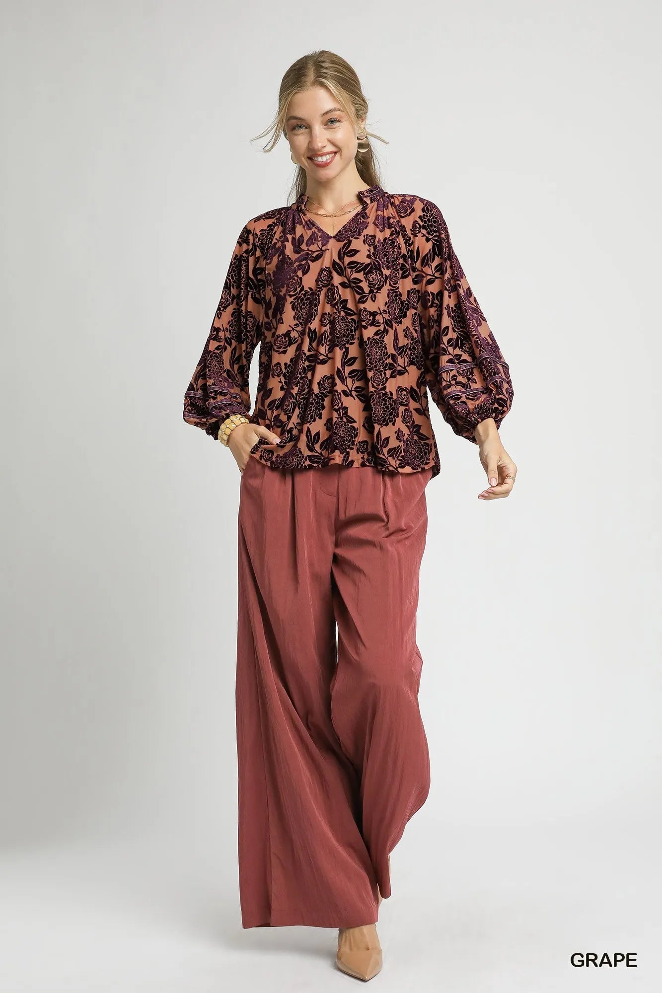 Umgee floral velvet blouse by Trendsi featuring balloon sleeves and a vibrant floral pattern, perfect for stylish, comfortable wear.