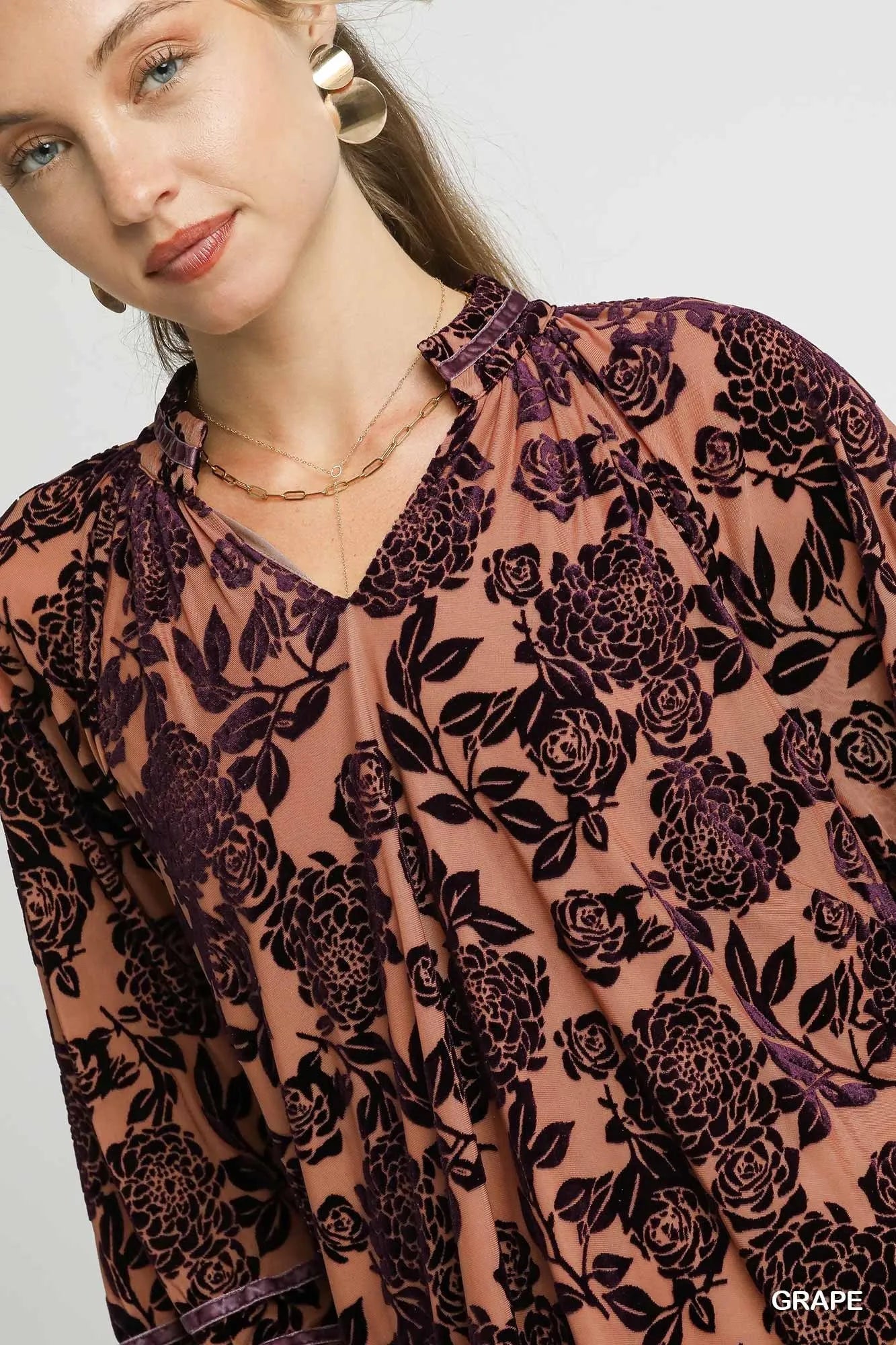 Umgee floral velvet blouse with balloon sleeves, showcasing a stylish floral print and elegant design.