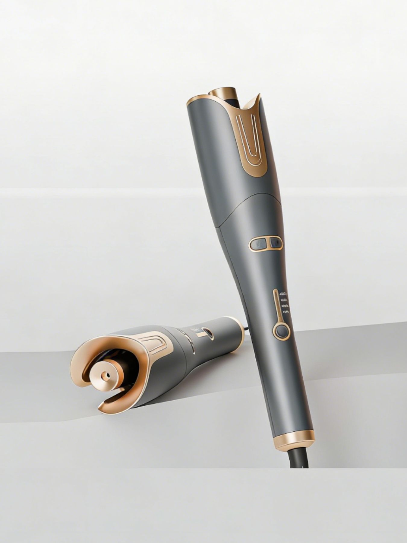 Gray automatic rotating hair curling iron by Trendsi with European plug, showcasing its sleek design and rotating barrel for curls.