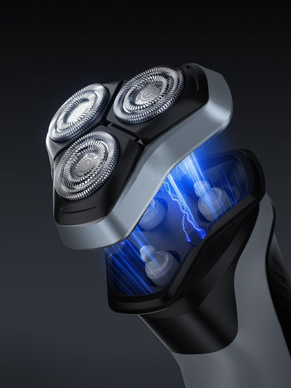 Gray rechargeable rotary electric shaver with LED display, showing close-up of the shaver's head and control panel.