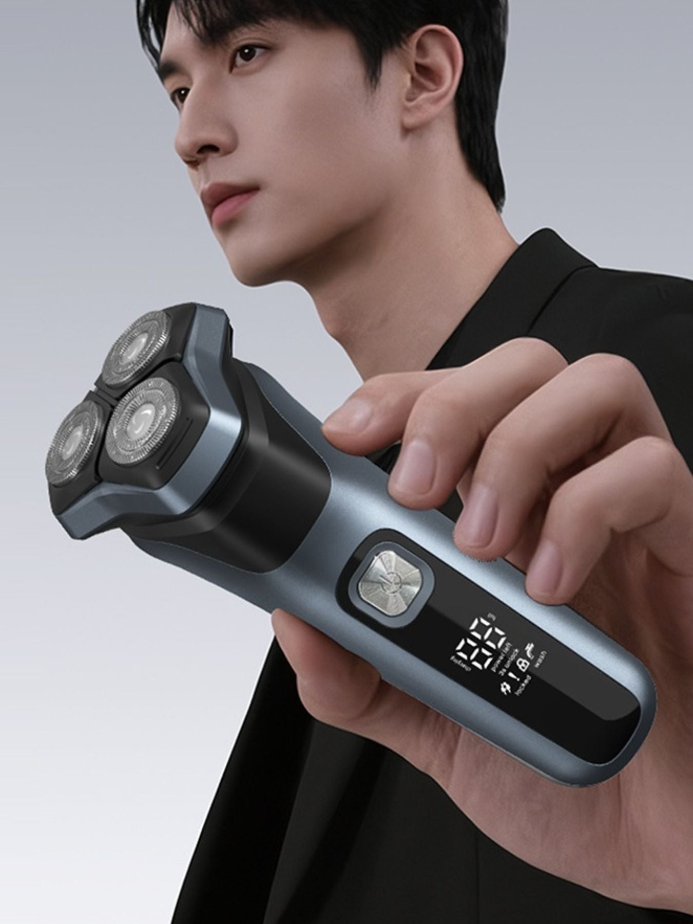 Gray rechargeable rotary electric shaver with LED display, compact design, and ergonomic handle for precise grooming.