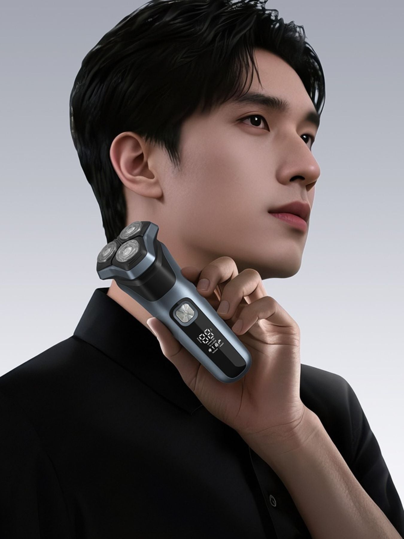 Rechargeable rotary electric shaver with LED display in gray, featuring multiple rotary blades for a close, comfortable shave.