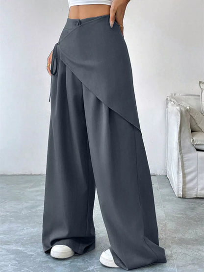 Gray asymmetrical wrap wide-leg pants from Trendsi, featuring a stylish, flowy design and high-waisted fit.