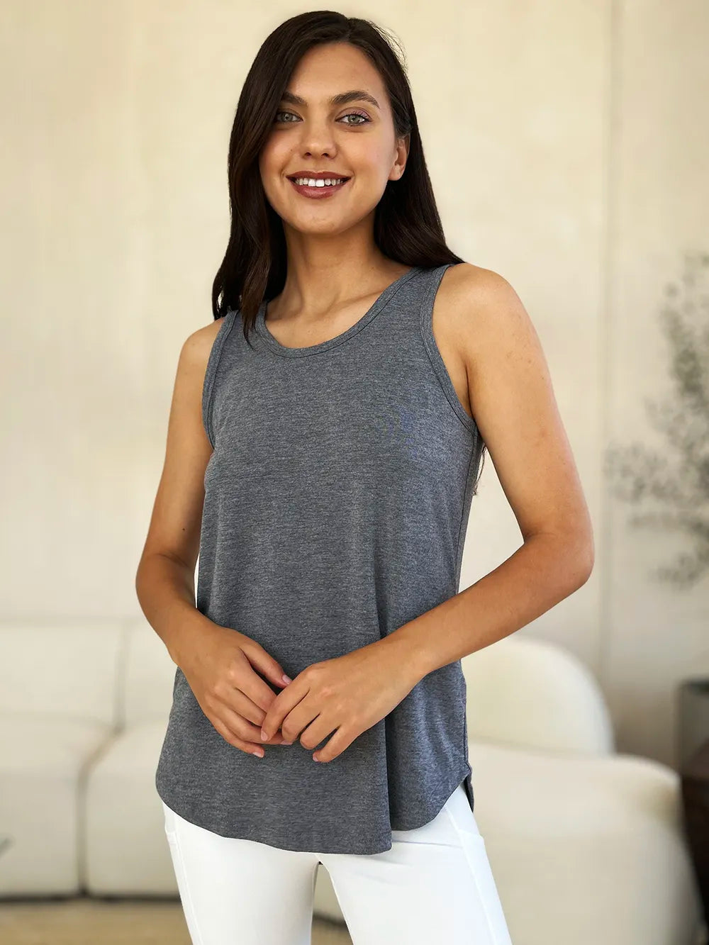 Gray Basics Bae full-size round neck curved hem tank top by Trendsi, displayed flat with a focus on the curved hem detail.