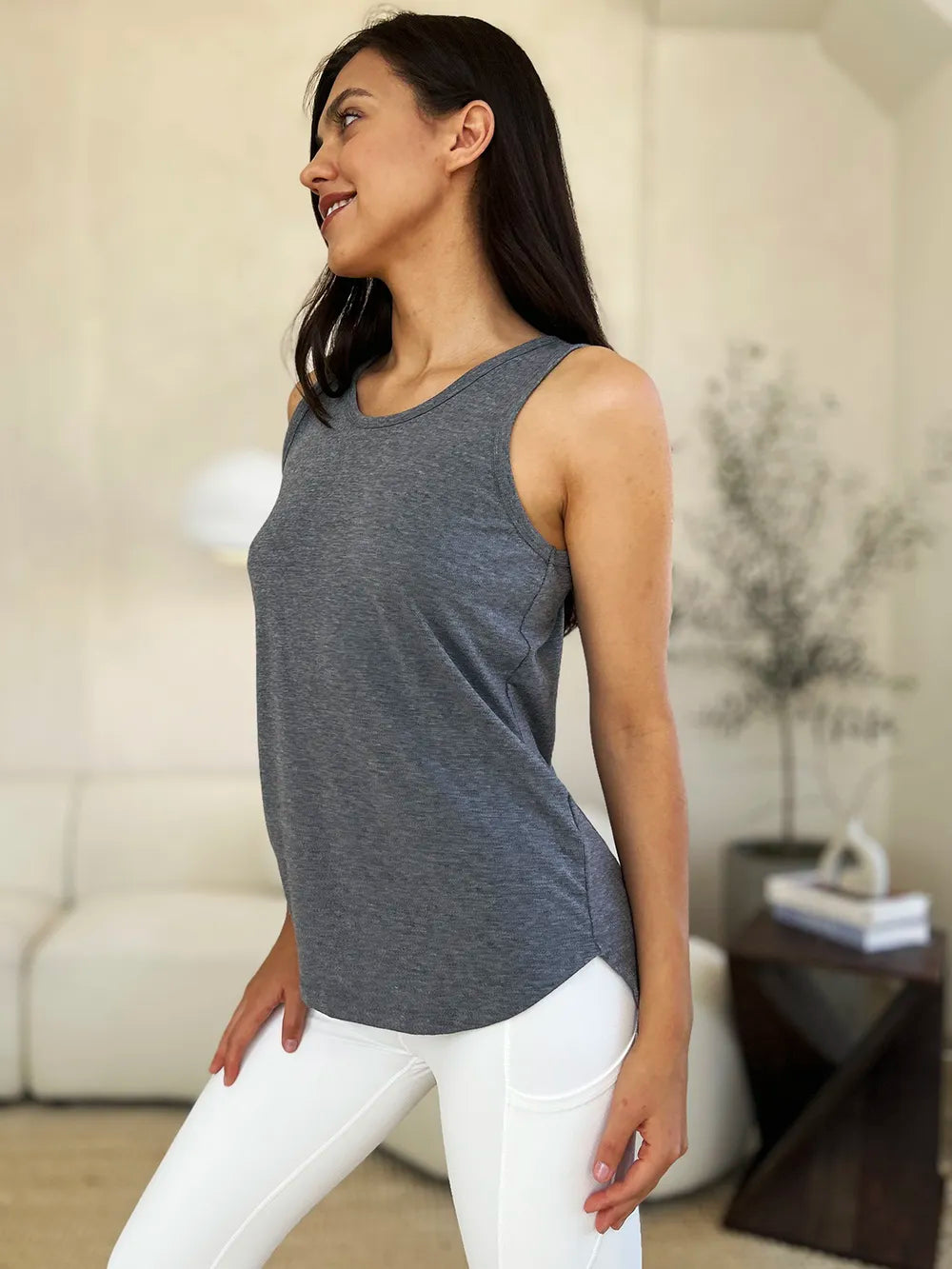 Gray Basic Bae full-size round neck curved hem tank top by Trendsi, shown on a mannequin with a casual fit and sleeveless design.