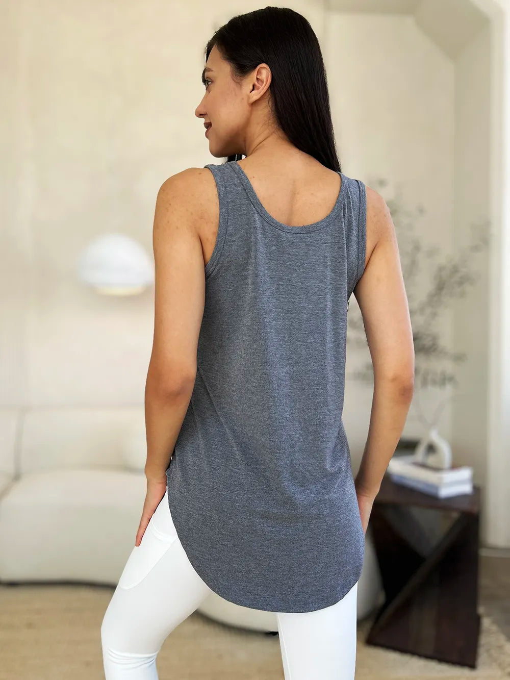 Gray basic Bae full-size round neck tank top with curved hem, from Trendsi, shown on a model.
