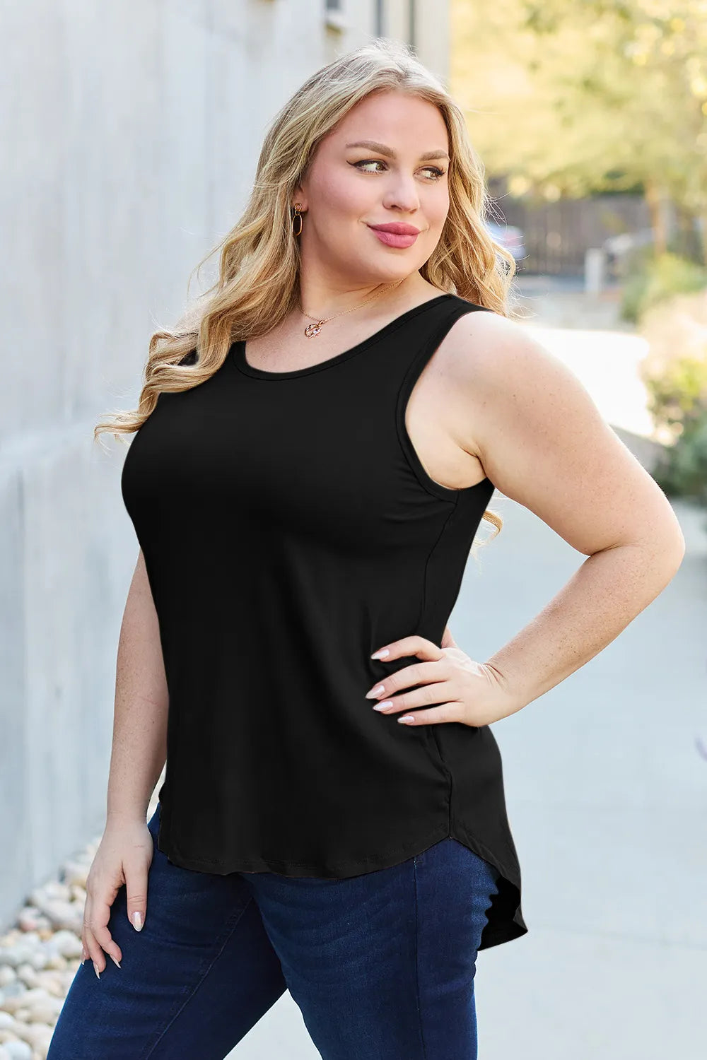 Gray Basic Bae full-size round neck curved hem tank top from Trendsi, casual sleeveless shirt with a relaxed fit and curved hem.