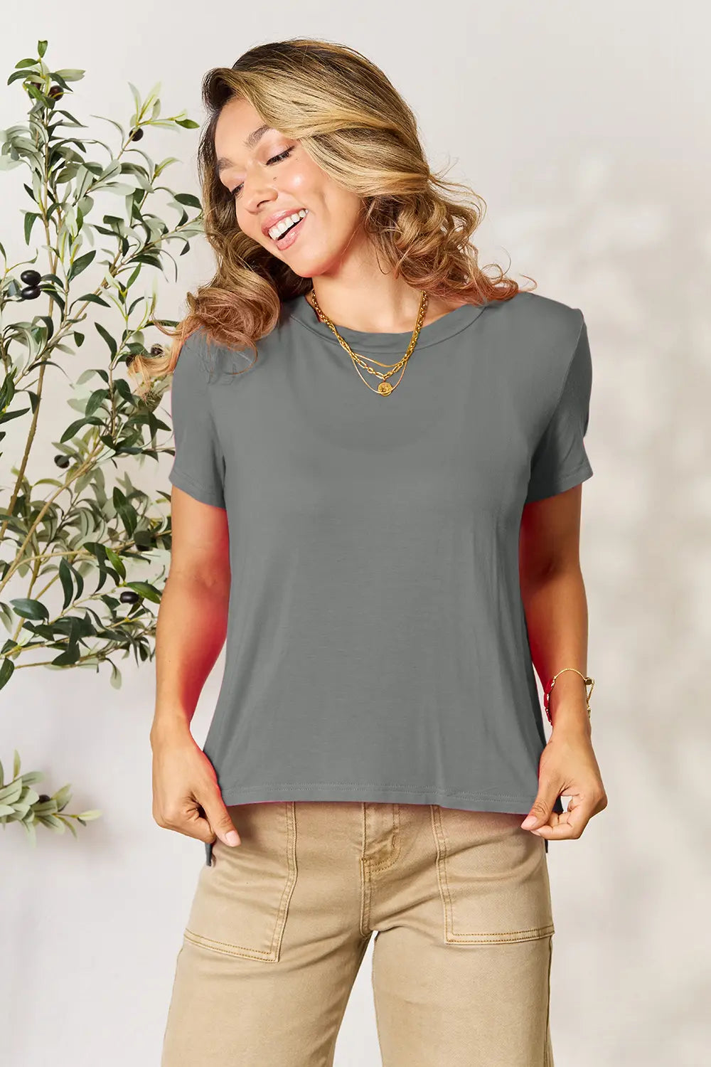 Gray Basic Bae full-size round neck short sleeve T-shirt from Trendsi, casual fit, soft fabric, worn by a model.