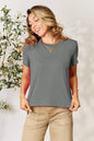 Gray Basic Bae full-size round neck short sleeve T-shirt from Trendsi, casual fit, soft fabric, worn by a model.