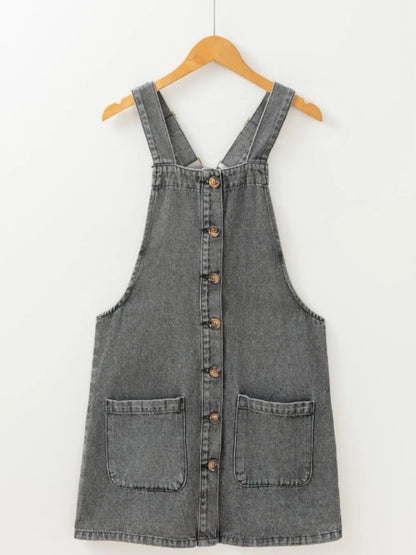 Gray wide strap button-down denim overall dress by Trendsi, featuring adjustable straps, front pockets, and a casual, stylish fit.