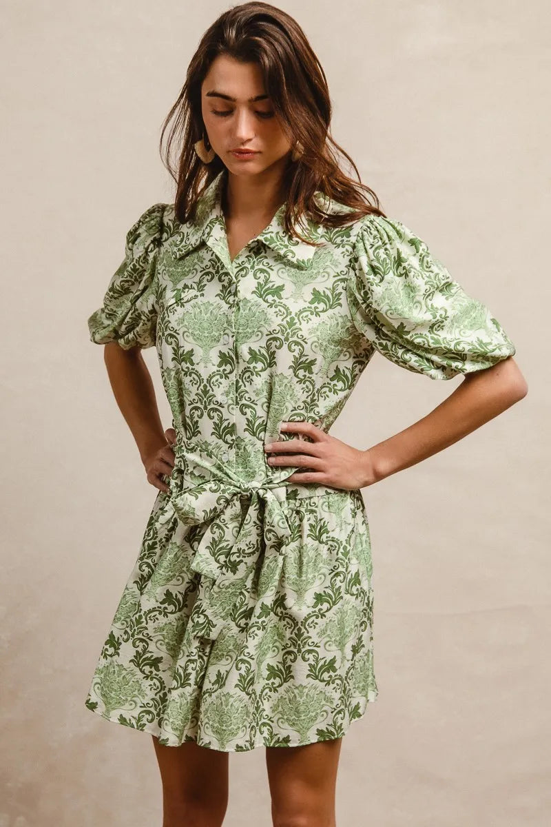 Green and cream floral short sleeve mini shirt dress with tie detail from Trendsi, perfect for casual summer wear.