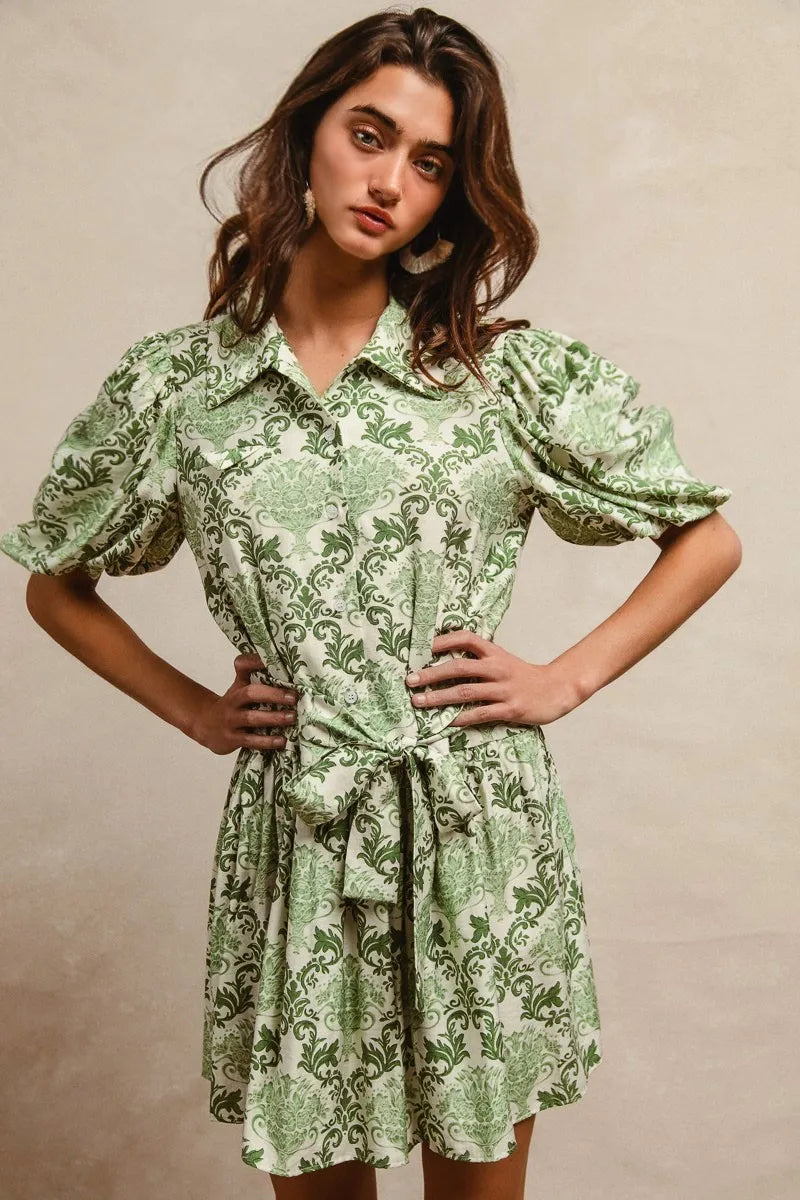 Green and cream floral short sleeve mini shirt dress with a tied waist from Trendsi, featuring a stylish and comfortable design.