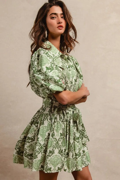 Green and cream floral short sleeve mini shirt dress with tie detail from Trendsi, styled for a casual summer look.