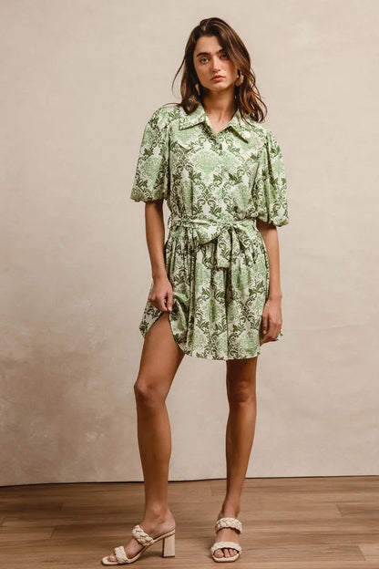 Green and cream BiBi Tied Floral Short Sleeve Mini Shirt Dress by Trendsi, featuring a relaxed fit and tied waist detail.