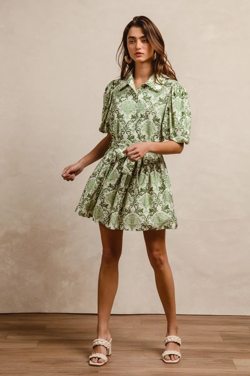 Green and cream floral short sleeve mini shirt dress with a tied waist, by Trendsi, styled with a casual, summery look.